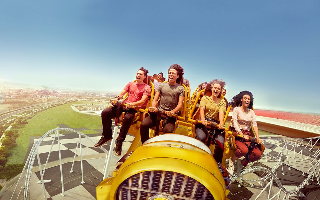 Visitors enjoying a roller coaster ride at Ferrari World Abu Dhabi.