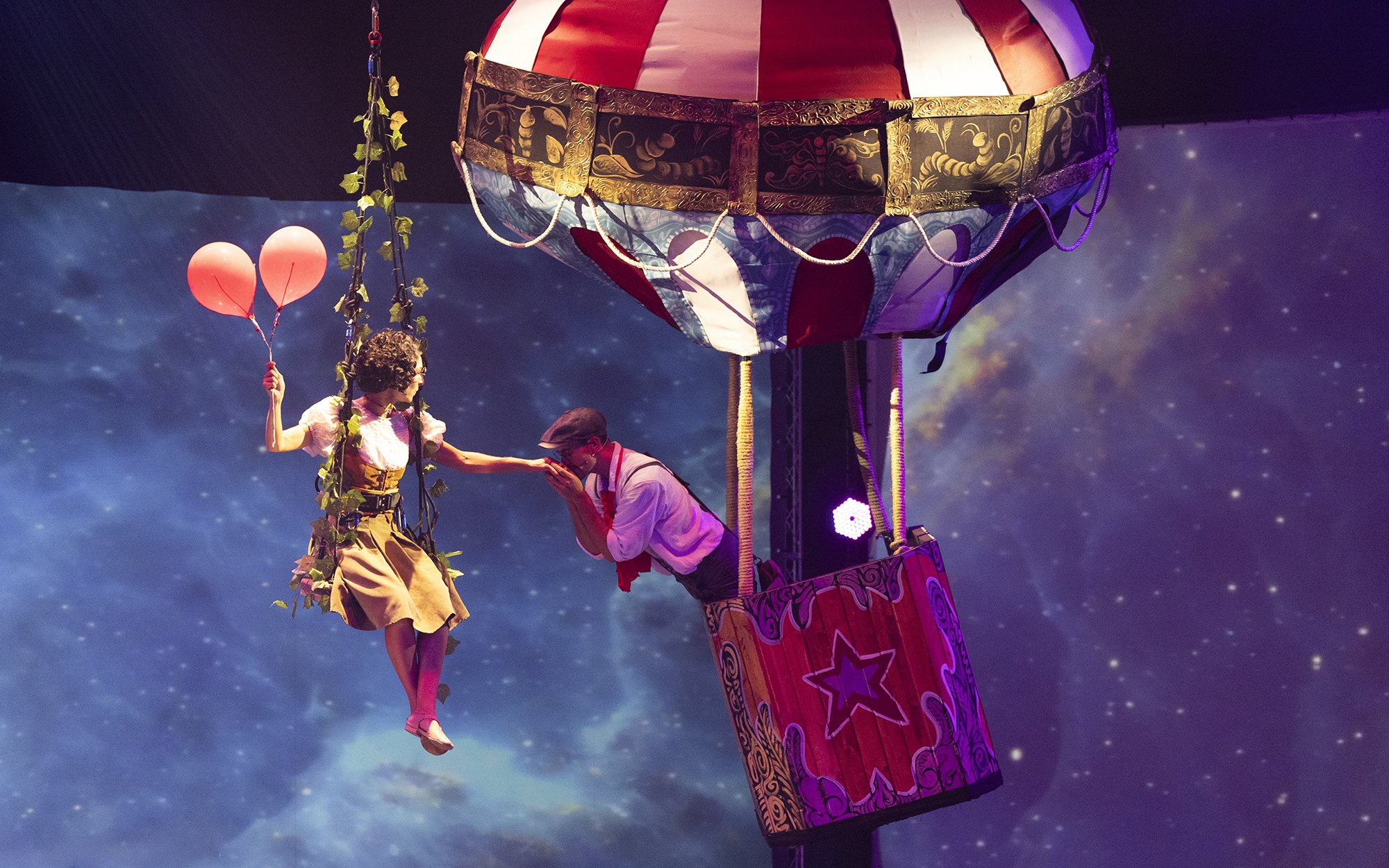 Performer with balloons near hot air balloon at Terra Mitica Benidorm show.