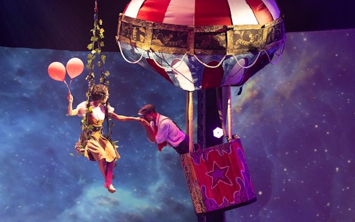 Performer with balloons near hot air balloon at Terra Mitica Benidorm show.