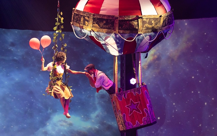 Performer with balloons near hot air balloon at Terra Mitica Benidorm show.