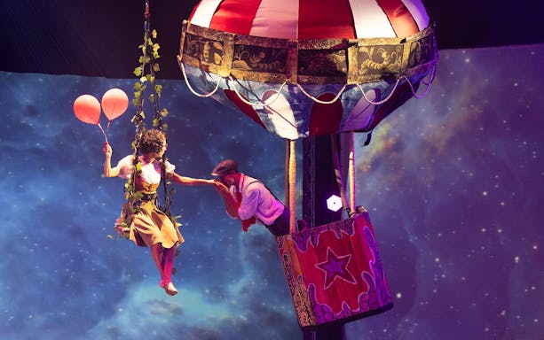 Performer with balloons near hot air balloon at Terra Mitica Benidorm show.