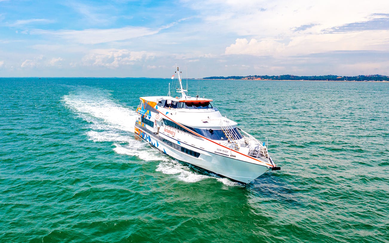 Ferry traveling from Singapore to Batam across blue ocean waters.