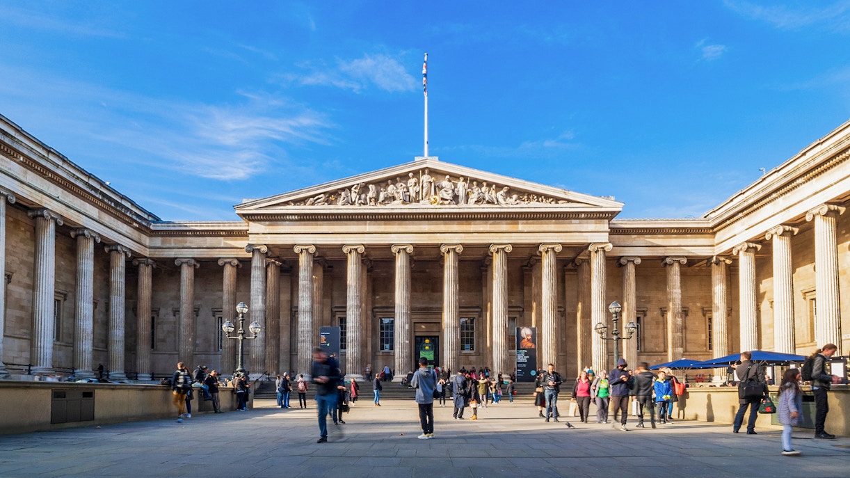 British Museum exterior with visitors in London, showcasing iconic neoclassical architecture.