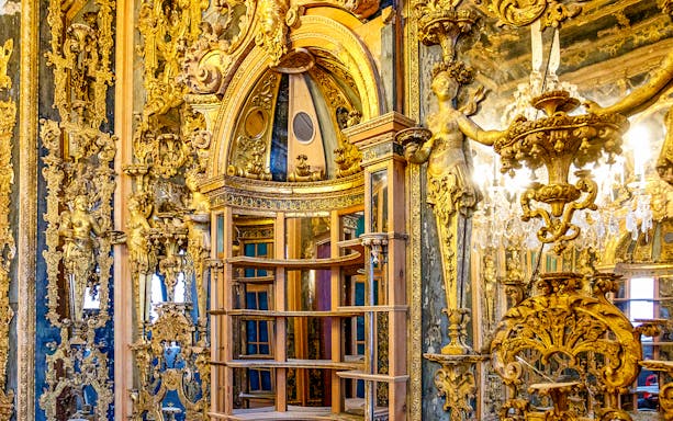 Ornate interior with gilded sculptures and intricate carvings at Bode Museum, Berlin.