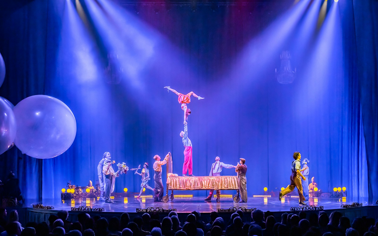 Cirque du Soleil Corteo performers in acrobatic act with suspended hoops.