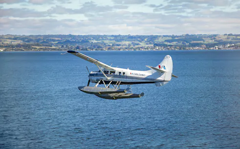 Floatplane flying over a lake near Mount Tarawera, New Zealand.