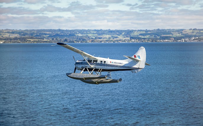 Floatplane flying over a lake near Mount Tarawera, New Zealand.