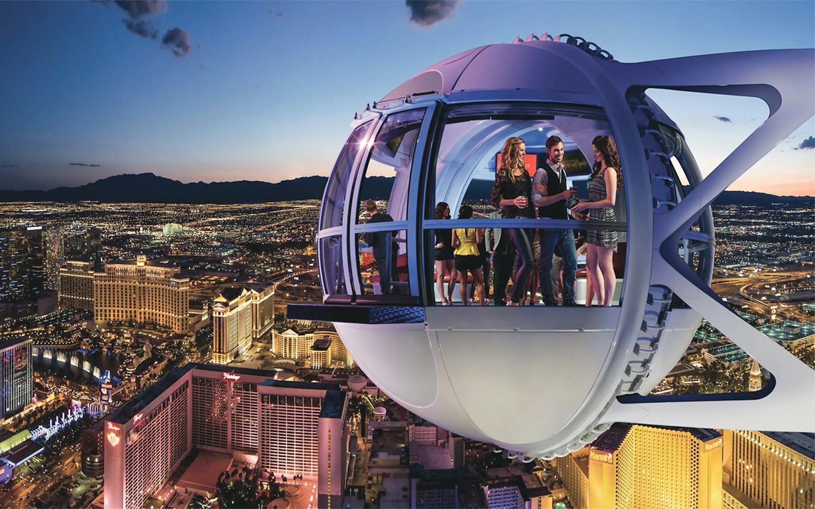 Guests enjoying the view inside the Las Vegas High Roller Observation Wheel at night.