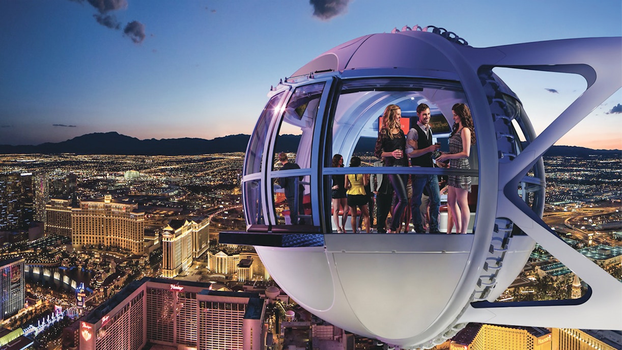 Guests enjoying the view inside the Las Vegas High Roller Observation Wheel at night.