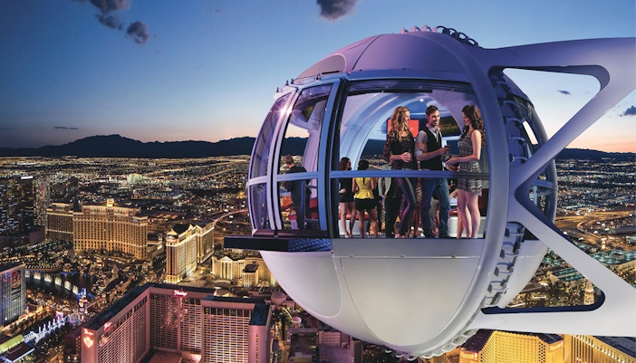 Guests enjoying the view inside the Las Vegas High Roller Observation Wheel at night.
