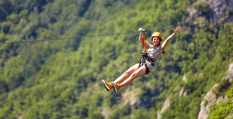 Female tourist ziplining in Rotorua