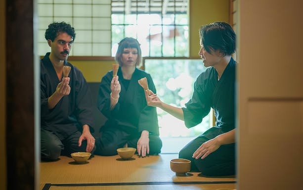 Guests participating in a private tea ceremony with traditional tools in Japan.