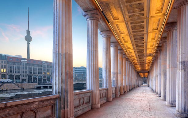 Colonnade walkway at Alte Nationalgalerie, Berlin, with TV Tower in the background.