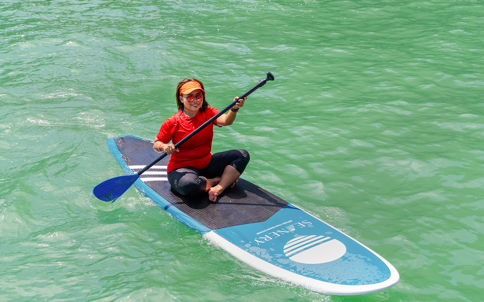 Local paddler canoeing on turquoise water.