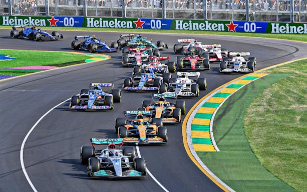 Formula 1 cars racing on track at Australia Grand Prix.