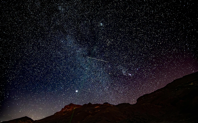 Starry night sky over Mount Teide in Tenerife, viewed from the National Park.