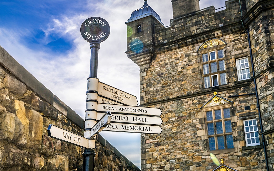 Signposts at Edinburgh Castle directing to Crown Square, Great Hall, and War Memorial.