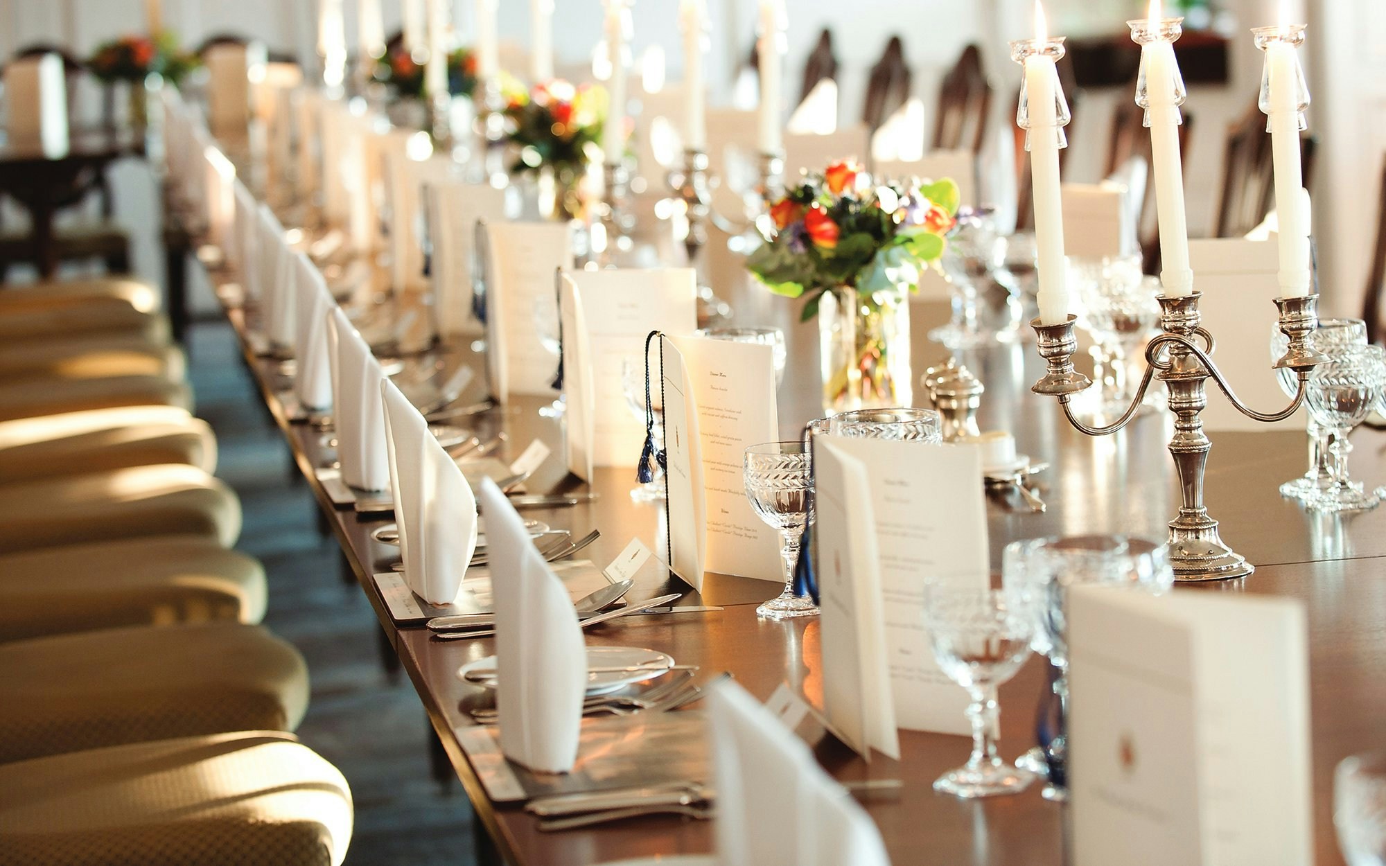 Royal Yacht Britannia state dining room table set with menus and candelabras.
