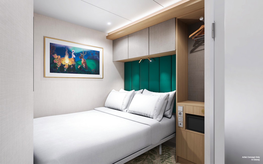 Concierge Suite with oceanview verandah on Disney Adventure Cruise, featuring a cozy bed and artwork.