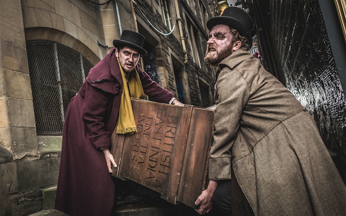 Two actors portraying Burke and Hare carrying a crate at Edinburgh Dungeon.