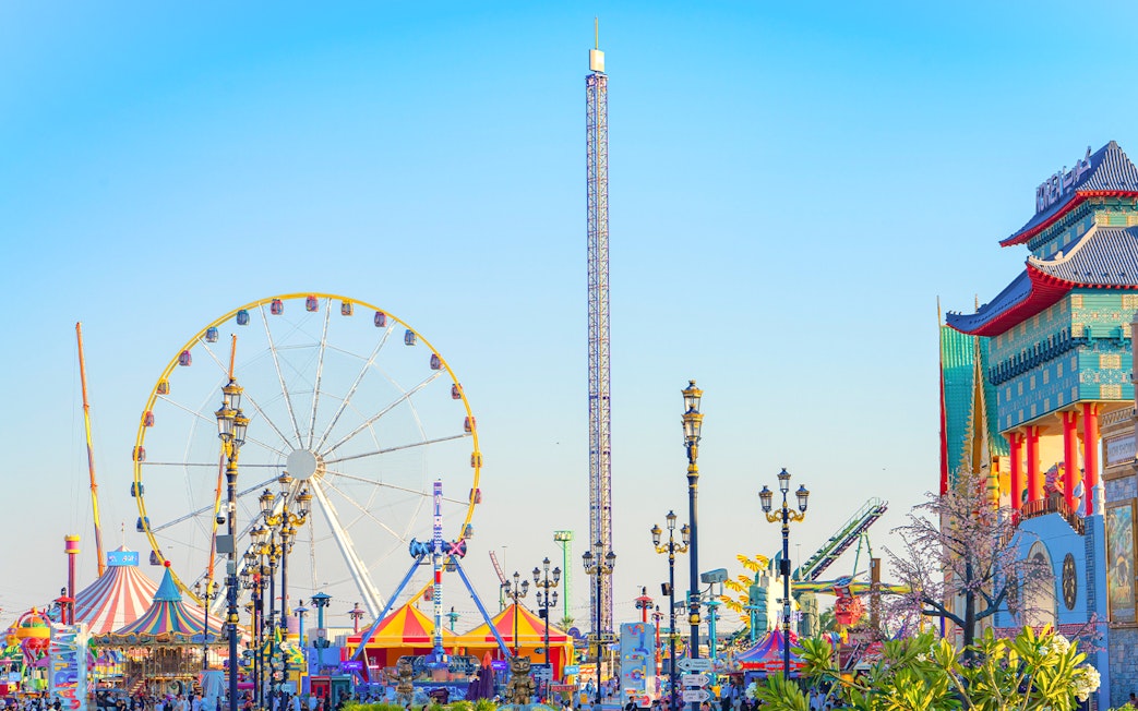 Ferris wheel and colorful attractions at Global Village Dubai.