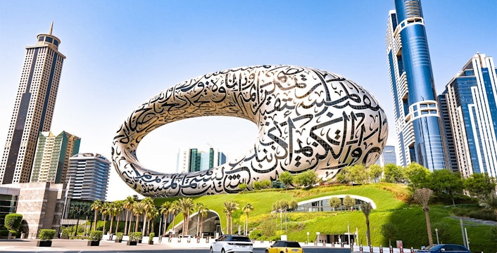 Museum of the Future in Dubai with Arabic calligraphy facade and surrounding skyscrapers.