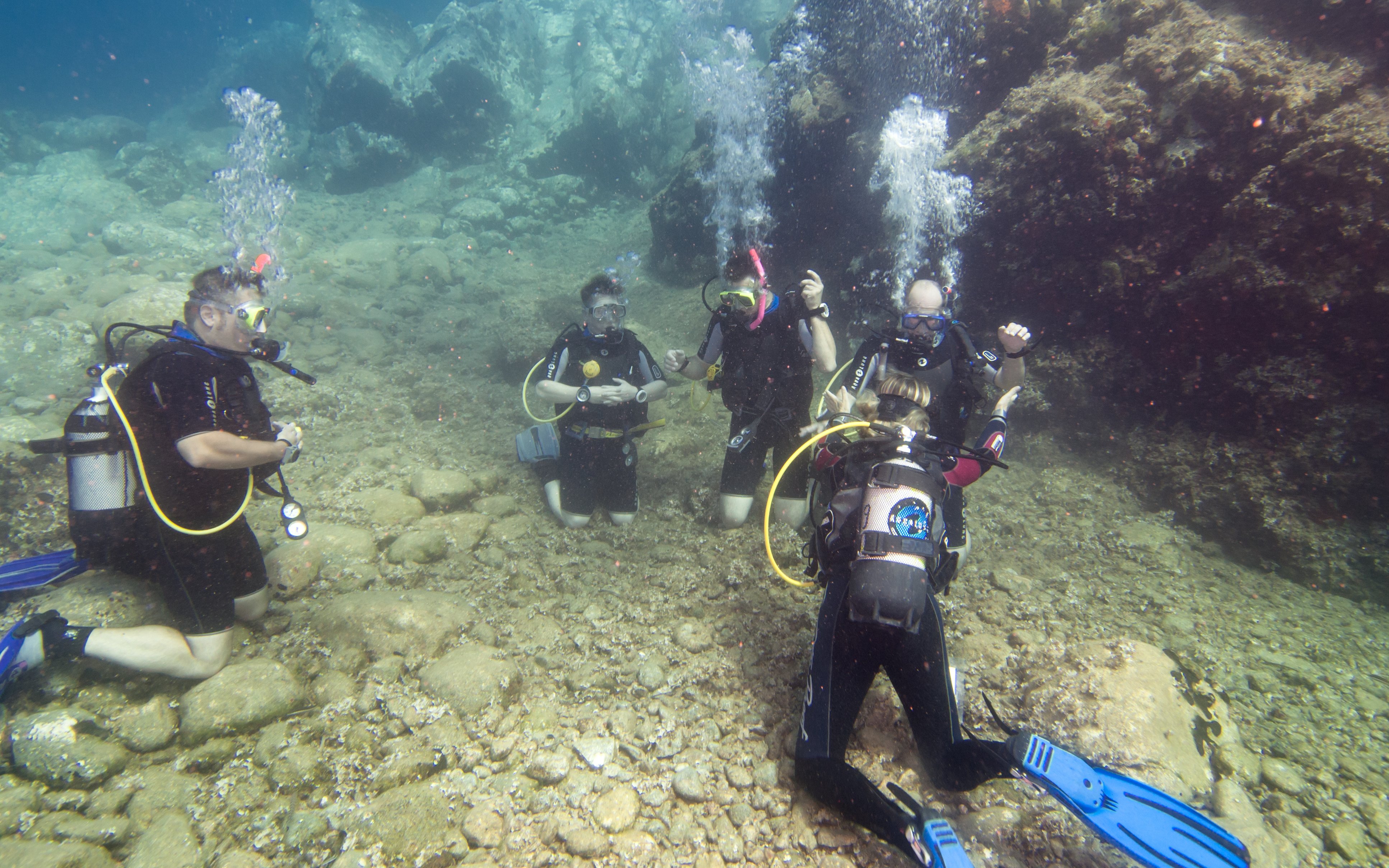 Scuba diving students practicing underwater skills during a course in Ibiza.