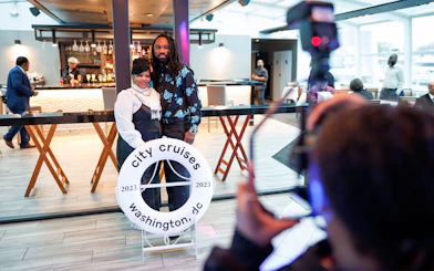 Guests posing for photos at Premier Bottomless Mimosa Brunch Cruise in Washington DC.