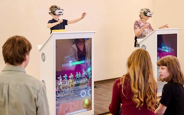 Guests using VR at Mozart Interactive Museum in Prague.