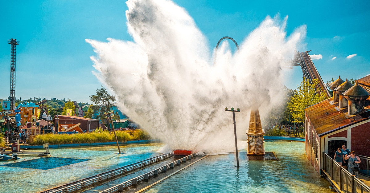 Tidal Wave Ride splash at Thorpe Park with roller coaster in background.