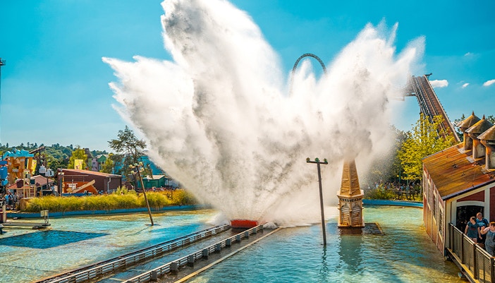 Tidal Wave Ride splash at Thorpe Park with roller coaster in background.