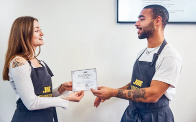 Participants receiving certificates at Traditional Chimney Cake Workshop, Budapest.