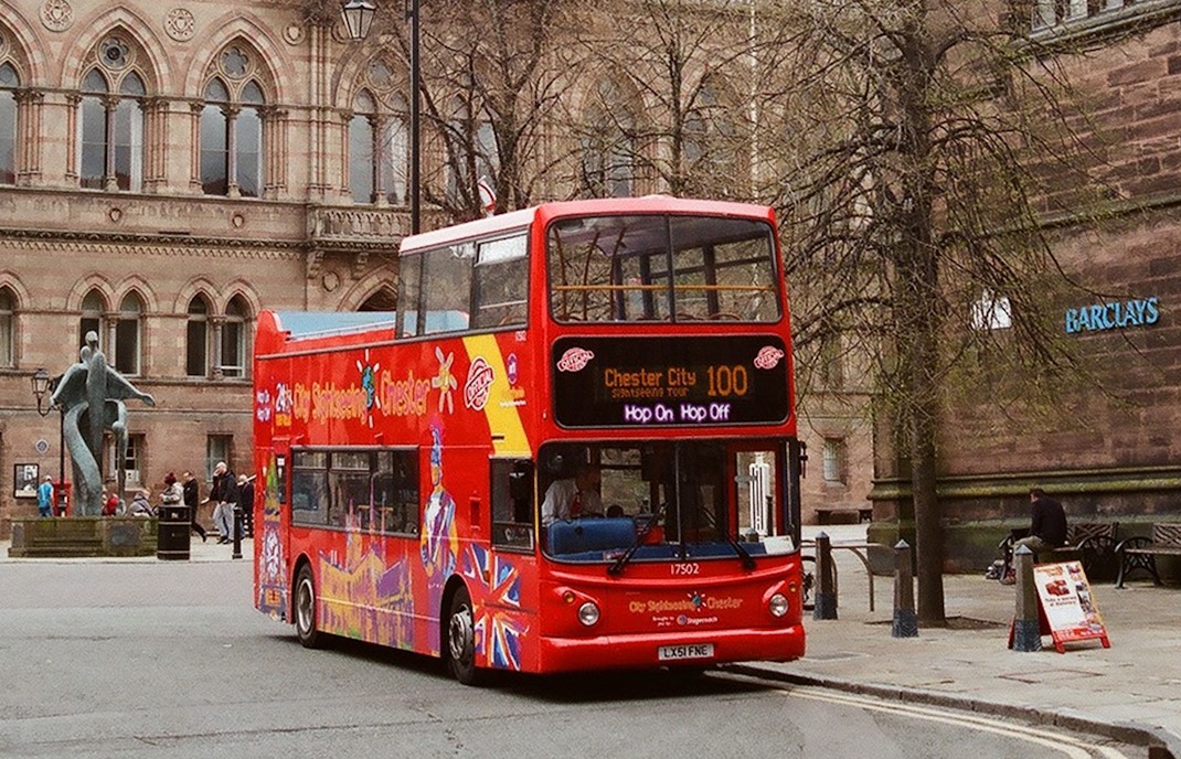 Chester cityscape with red double-decker bus on 24/48-Hr Hop-On Hop-Off Tour.