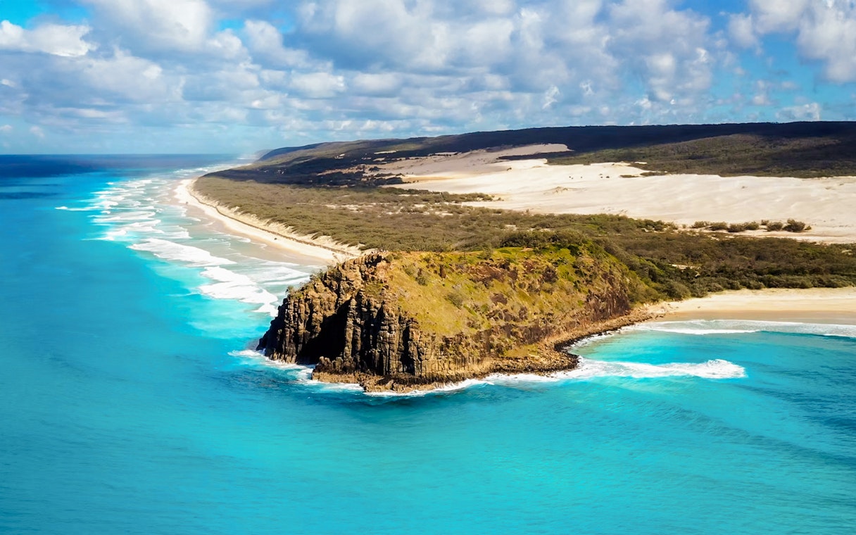Aerial view of Fraser Island's coastline with turquoise waters and sandy beaches, K'gari.