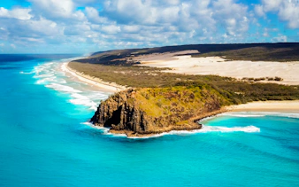 Aerial view of Fraser Island's coastline with turquoise waters and sandy beaches, K'gari.