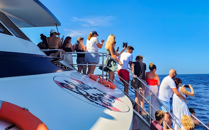 Tourists on a Gran Canaria cruise boat watching for dolphins.