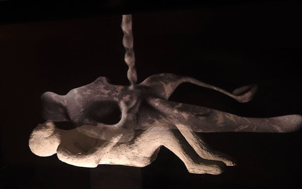 Pompeii plaster cast of a victim displayed in the Magic Ancient Pompeii Virtual Museum.