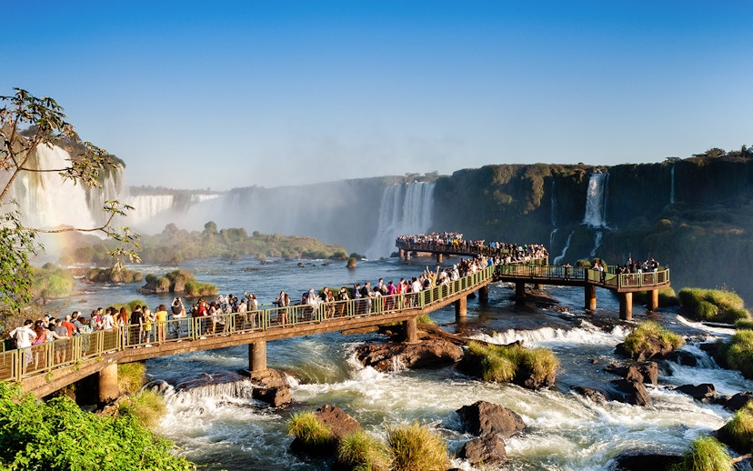 Visitors on a walkway overlooking Iguazu Falls, Brazil.