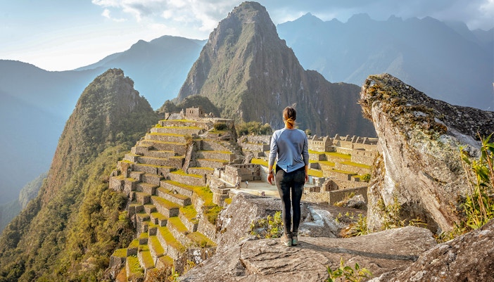 Woman standing in front of Machu Picchu in Peru