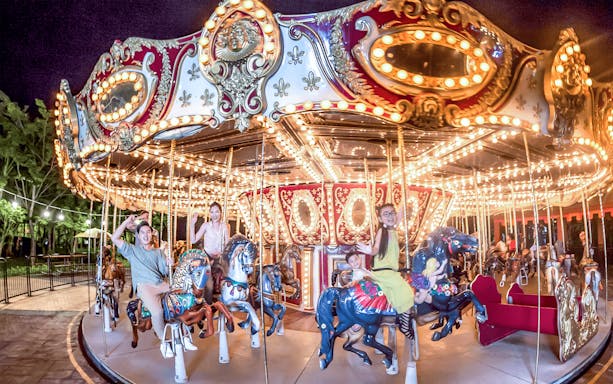 Festival Carousel at Sun World Da Nang with people enjoying the ride.