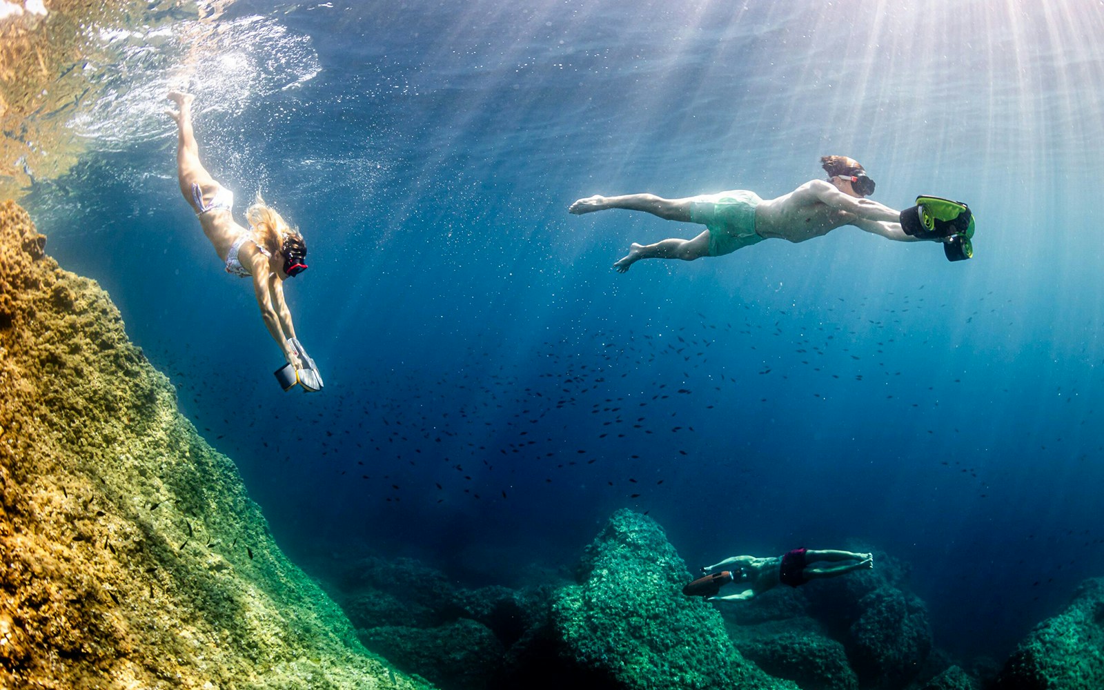 Underwater scooter riders exploring marine life in Marseille.