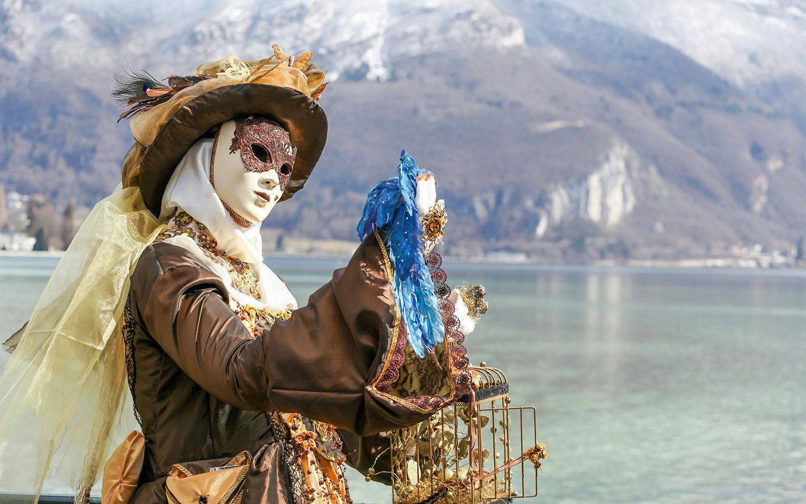 Venice Carnival attendees wearing traditional Volto masks in a vibrant street celebration.