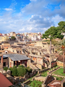 Ancient ruins of Herculaneum with modern town in background, Sorrento to Herculaneum tour.