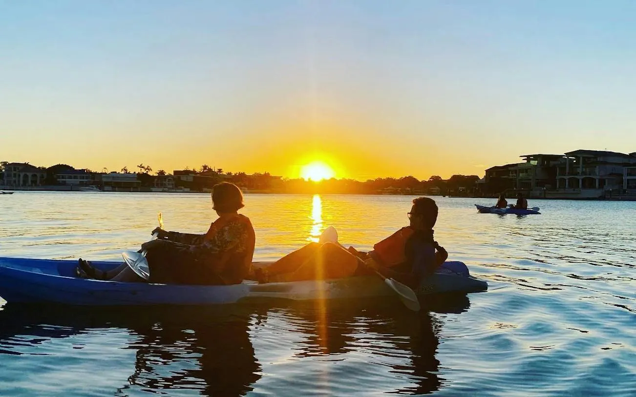 Kayakers enjoying sunset on Surfers Paradise Guided Kayak Tour, Gold Coast.