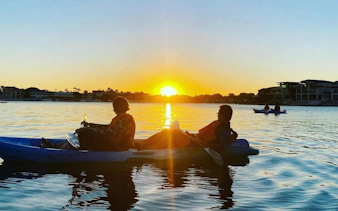 Kayakers enjoying sunset on Surfers Paradise Guided Kayak Tour, Gold Coast.