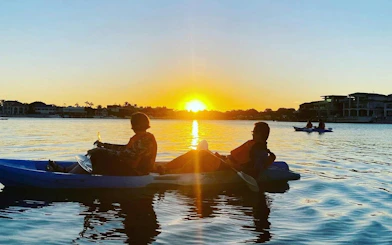 Kayakers enjoying sunset on Surfers Paradise Guided Kayak Tour, Gold Coast.