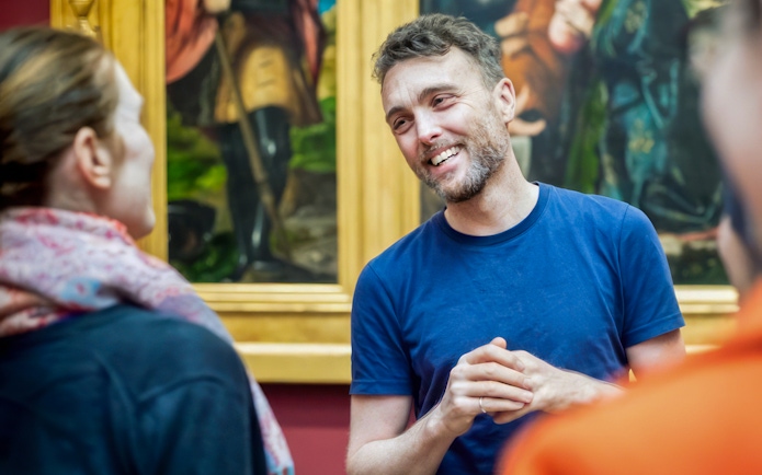 Guide explaining artwork during National Gallery tour.