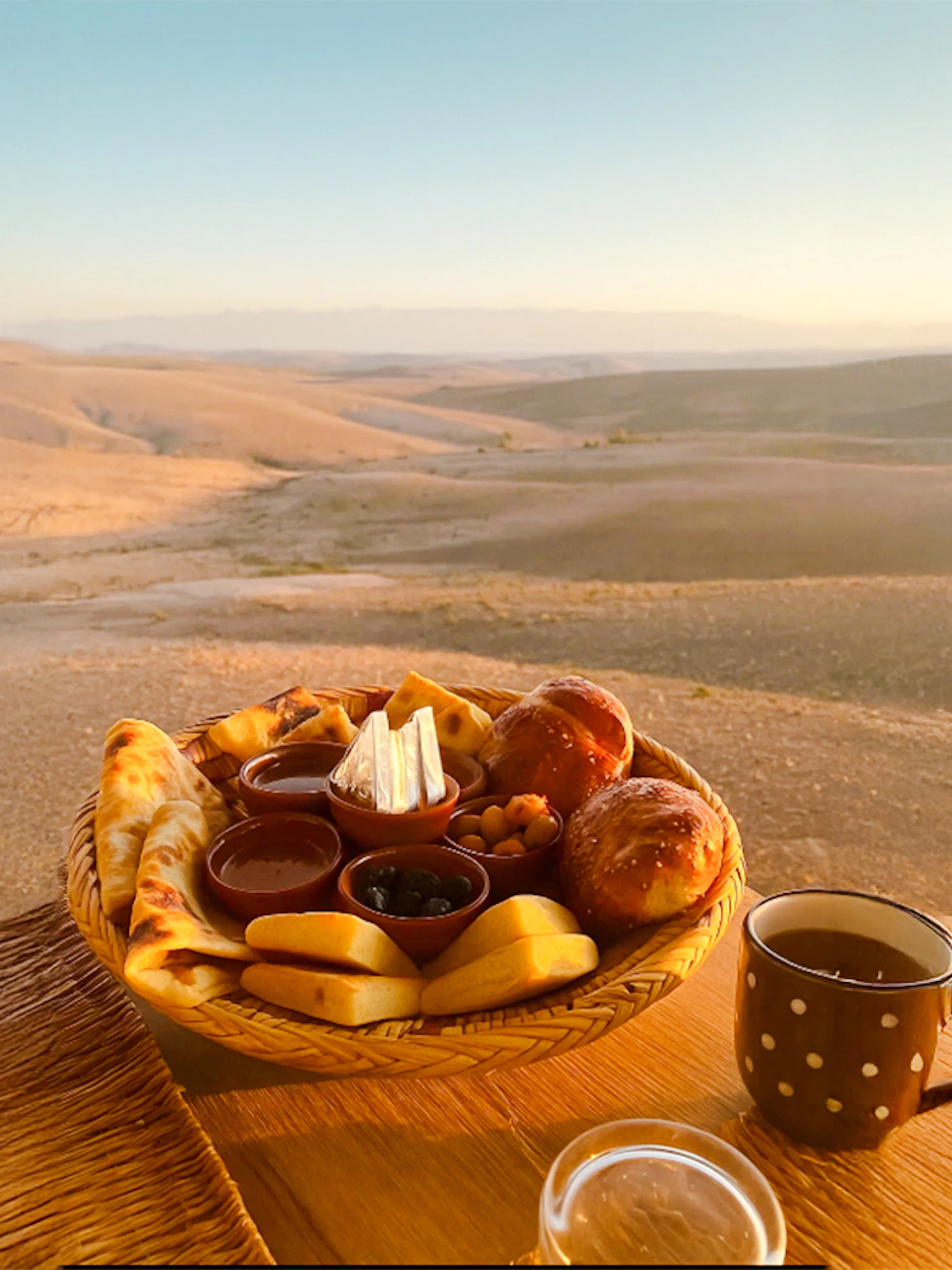 Breakfast spread with pastries and tea in Agafay desert, Marrakech.