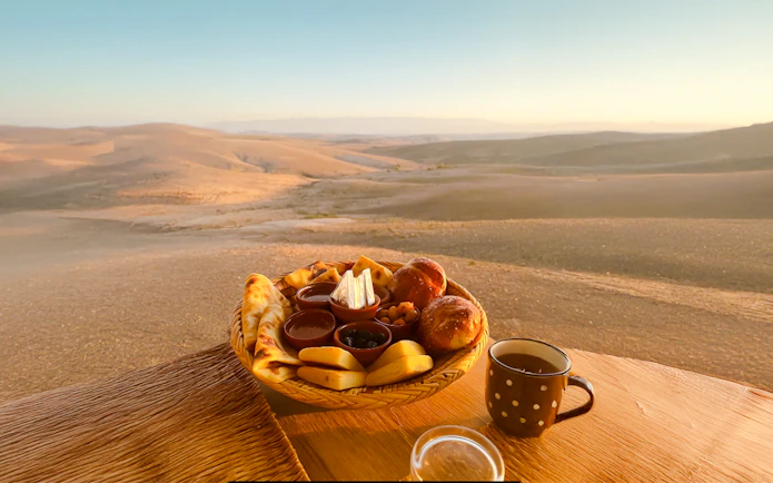 Breakfast spread with pastries and tea in Agafay desert, Marrakech.
