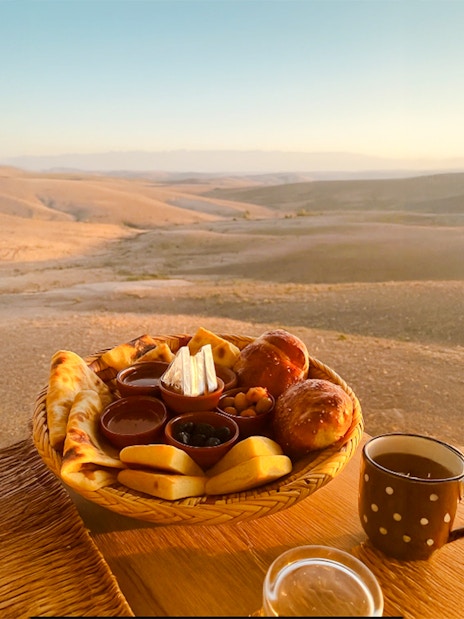 Breakfast spread with pastries and tea in Agafay desert, Marrakech.